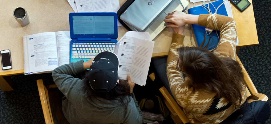 Students studying at a table in the library (aerial shot)