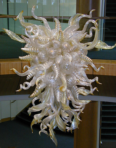 a photograph of a Dale Chihuly glass sculpture that hangs between the library first and second floors