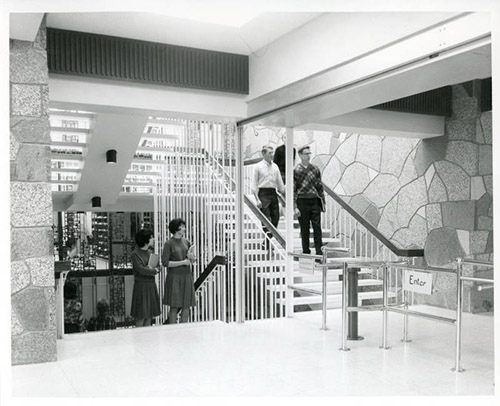 library patrons are pictured on the staircase in UMD's old library. image is from 1969