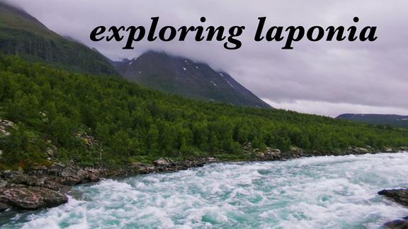 landscape of lapland with mountain, fog, trees, and rushing river