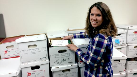Lisa Wheeler in front of boxes of library materials