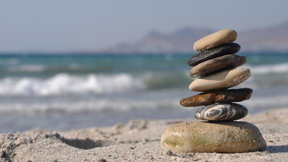 a cairn of small rocks stacked on a beach