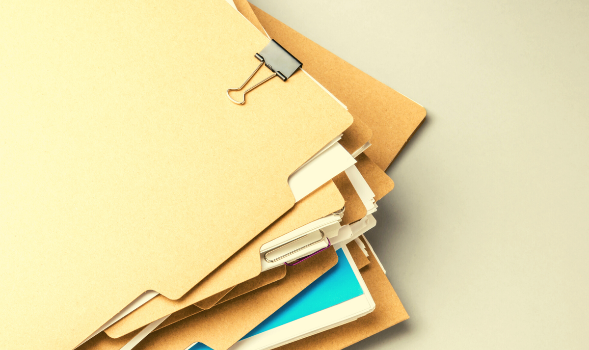 stack of file folders on a work surface