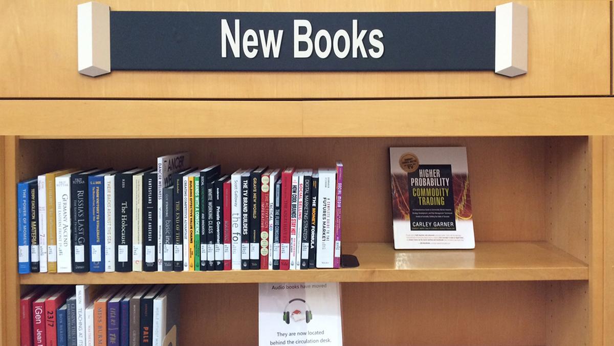 new books sign and shelf at the library