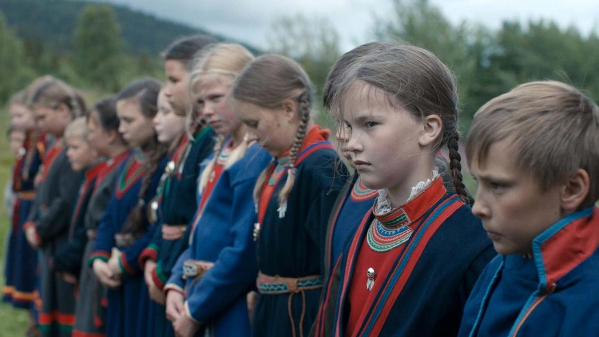 A still image from Sami Blood film - a row of children dressed in traditional sami garb