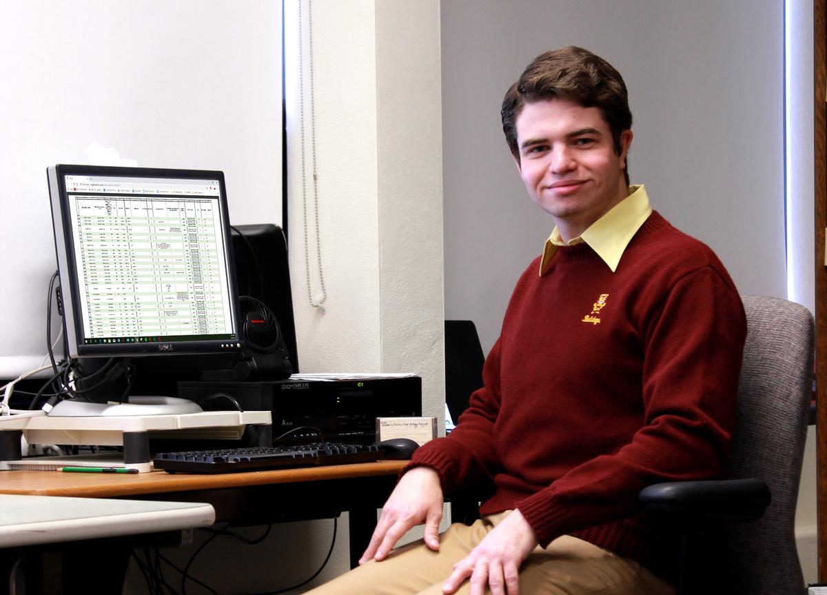 Student Tucker Nelson Sits At His Desk